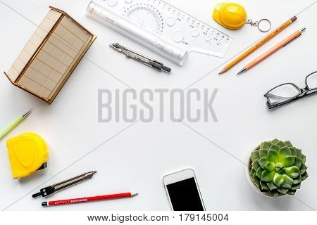 architect working desk with flower, mobile and ruler on white background top view mock up