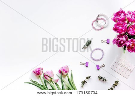 Woman office desk with spring flowers trend on white background top view mockup