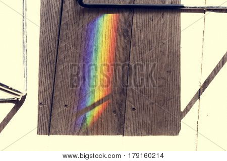 Rainbow reflect on the shadow of the chair