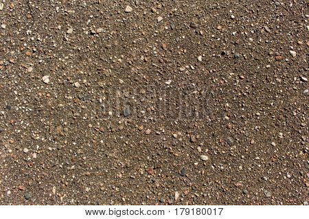 Close up detailed view of coarse asphalt road coating background or texture