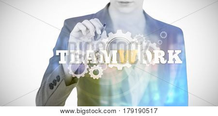 Businesswoman using invisible digital screen against teamwork text with gears 3d
