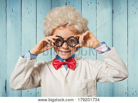 Digital composite of Boy genius against blue wood panel