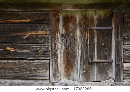 Old wooden rusty cabin door with antique locke. Norway