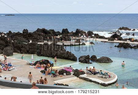 PORTO MONIZ MADEIRA PORTUGAL - SEPTEMBER 5 2016: Natural rock pool of Porto Moniz. It is a public bath with water from the Atlantic Ocean.