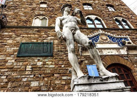 The famous statue David of Michelangelo (reproduction) in front of the entrance of the Palazzo Vecchio, now the City Hall in Piazza della Signoria. Florence, Italy