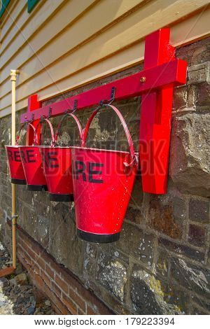 Red fire buckets on the side of the signal box at Instow