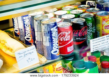 Paris France - October 08 2015: Several soft drink cans in a shop window. We can see various cans of Orangina Coca Cola classic Coca Cola Zero Coca Cola Life Lipton and Jocker