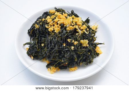 Chinese Traditional Food, Stir Fried Jute Leaves or Mulukhiyah Leaves with Garlics and Fermented Soy Bean.