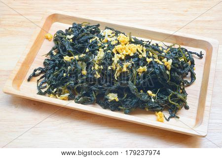 Chinese Traditional Food, Stir Fried Jute Leaves or Mulukhiyah Leaves with Garlics and Fermented Soy Bean.