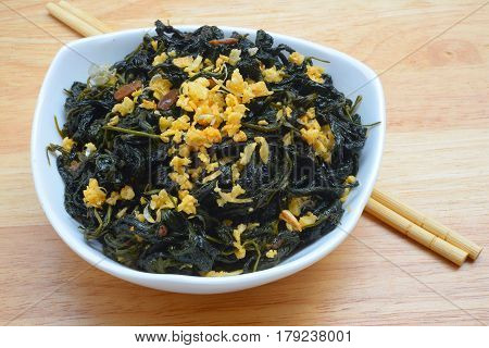 Chinese Traditional Food, Stir Fried Jute Leaves or Mulukhiyah Leaves with Garlics and Fermented Soy Bean.
