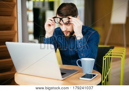 Business Man With Glasses Having Eyesight Problems Confused With Laptop Isolated On Office Backgroun