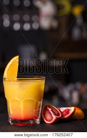 Alcoholic beverage based on table with ice cubes and oranges