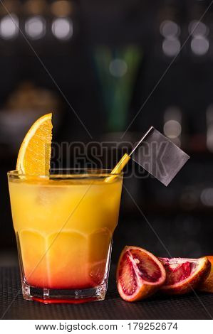 Alcoholic beverage based on table with ice cubes and oranges