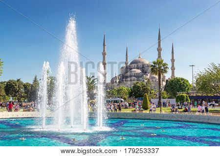 ISTANBUL - MAY 25, 2013: Tourists walk next to the Blue Mosque in Istanbul's historic center. The Blue Mosque is a historical monument and a beautiful mosque in Istanbul.
