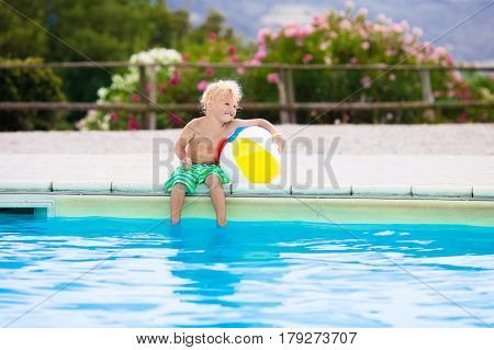 Child In Swimming Pool On Summer Vacation