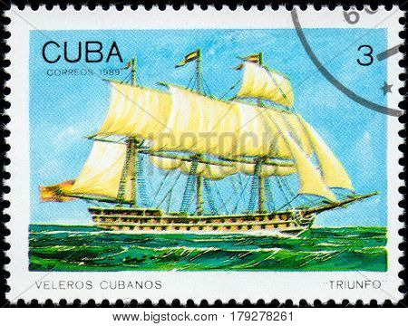 UKRAINE - CIRCA 2017: A postage stamp printed in Cuba shows sailing ship Triunfo Triumph from the series Cuban sailboats circa 1989