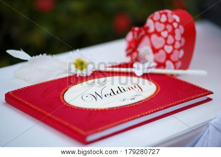 The red wedding guess book with cute pen