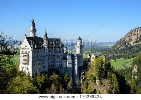 Beautiful view of world-famous Neuschwanstein Castle, the 19th century Romanesque Revival palace built for King Ludwig II, in beautiful evening light at sunset, Fussen, southwest Bavaria, Germany.