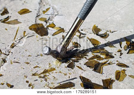 Hammer Hitting a Glass Bottle and Smashing it into Smithereens