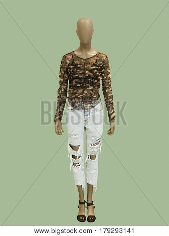Full-length female mannequin dressed in fashionable clothes. Isolated on green background. No brand names or copyright objects.
