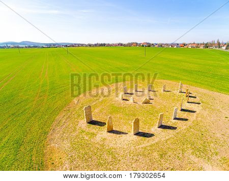 Aerial view of ancient esoteric geomancy symbol in green wheat field. Mystery of Czech countryside. Spring landscape near Pilsen. Czech Republic, Central Europe.