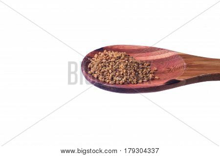 Fenugreek Seeds On A Brass Spoon Isolated On A White Background.