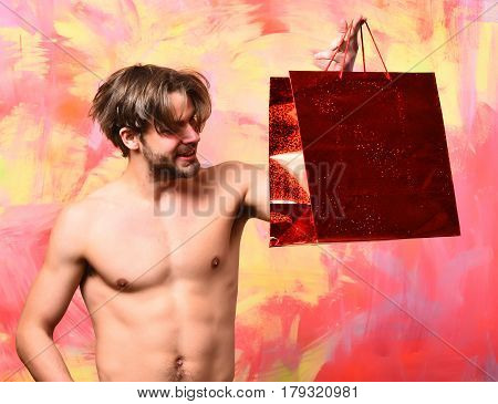 Caucasian Bearded Sexy Macho Man Holding Red Package Or Bag