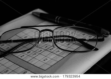 Solving Sudoku sharpens the brain - hobby - glasses pen