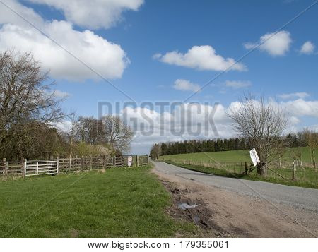 Single lane road through English countryside and farmland