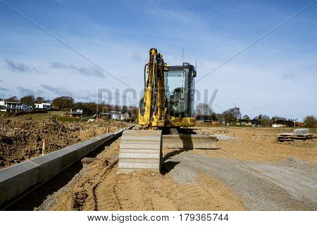 Yellow Excavator Digging On A Construction Site