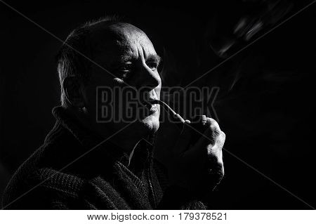 Black and white portrait of a caucasian man with tobacco pipe