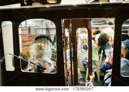 Little dolls in public transport tram rush hour in the children's puppet theater