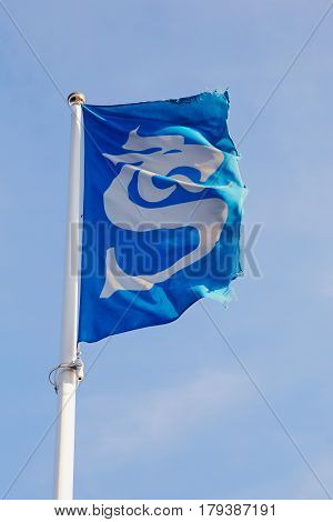 Sundsvall Sweden - July 24 2016: The flag with the symbol of the Sundsvall municipality raised on on flagpole.