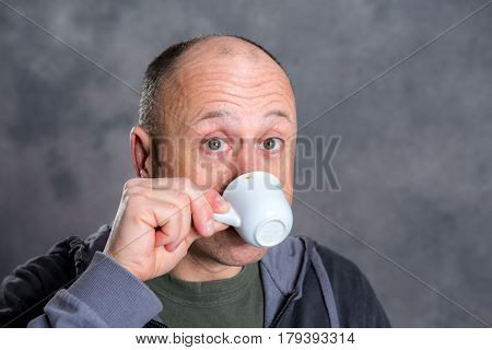 Young Baldheaded Man Drinking Coffee