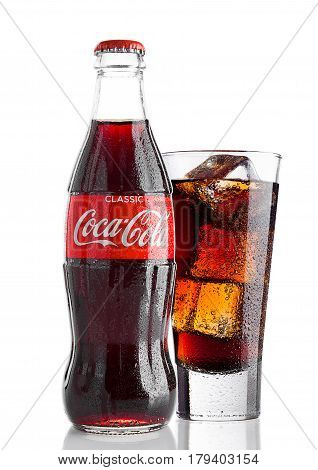 London,uk - March 30, 2017 : Bottle And Glass With Ice Cubes Of Coca Cola On White.