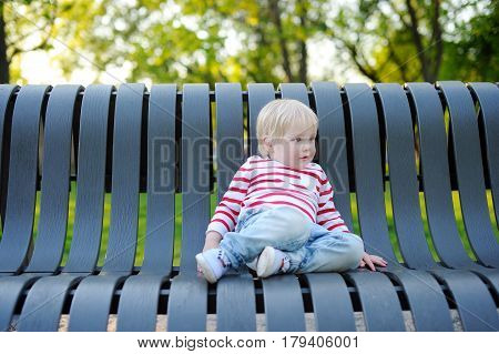 Toddler Boy On A Bench