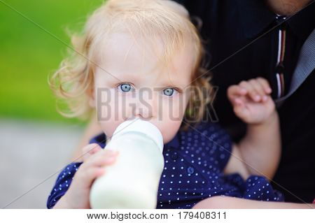 Toddler Girl Drinking Milk From Bottle