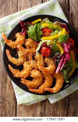 Shrimp In A Breaded And Salad Of Fresh Vegetables Close-up On A Plate. Vertical Top View