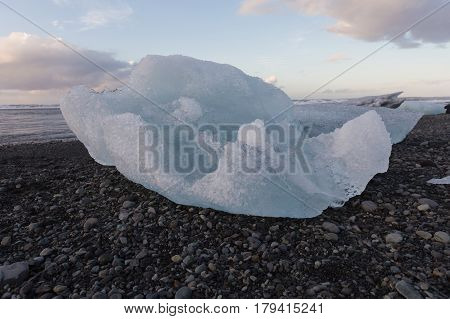 Natural Ice cube breaking on black sand beach Iceland winter landscape background