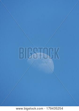 The growing moon in the blue sky