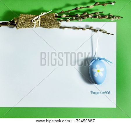 Easter composition with colorful eggs on a green background with copy space