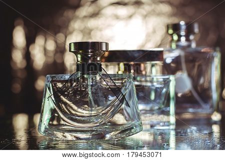 three different female perfume in gold background