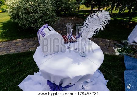 Wedding box glasses pen and towel on a table outdoors