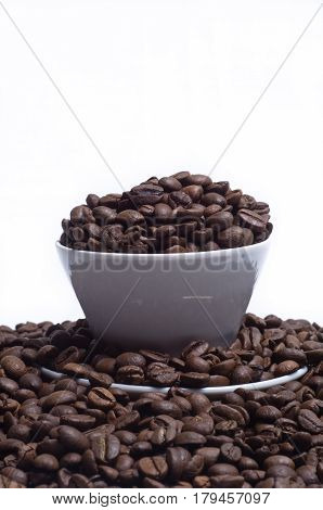 White cup with coffee beans on white background