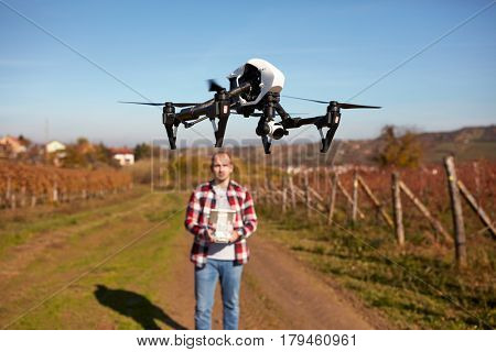 Drone hovering over ground and filming vineyard 