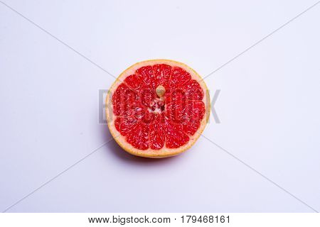 Half A Fresh Red Grapefruit On White Background
