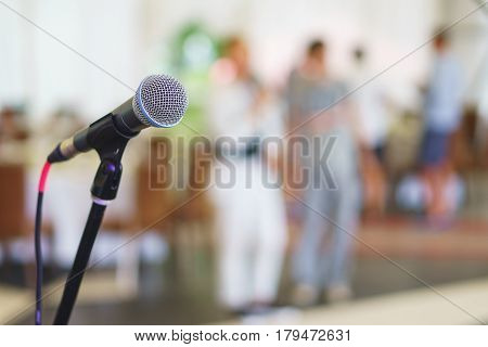 Stand with microphone on the stage prepared for presentation to the public speaker. equipment for live performance musicians. Soft focus