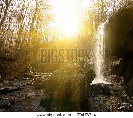 Waterfall in the wood at sunny morning