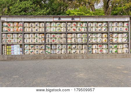 KAMAKURA JAPAN - APRIL 14 2014: Stack of Japanese wine (sake) barrels at a shrine on April 14 2014 in Kamakura Japan. Japanese donate wine to the temples and shrines as offering for the Gods.