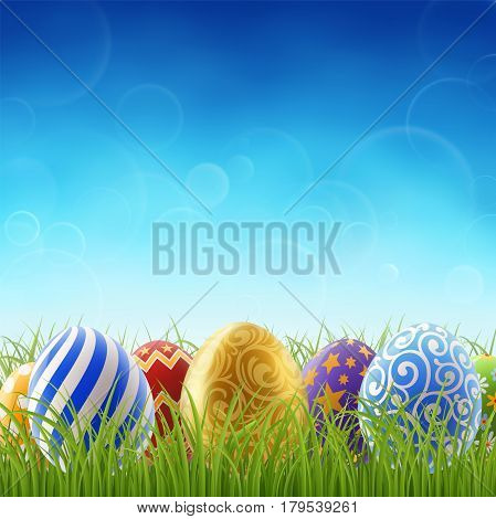 Background for easter holiday painted easter eggs on the grass on the background of clear blue sky. EPS 10 contains transparency.